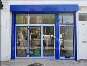 Giant Shopfront Shutter - Toughened glass and timber shopfront